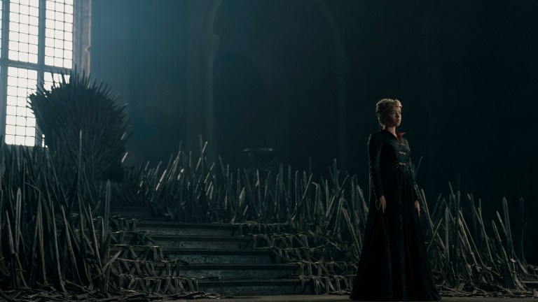 Young Princess Rhaenrya (Milly Alcock) stands in front of the Iron Throne in House of the Dragon season 2